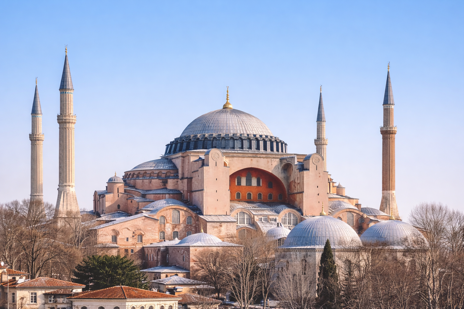 Hagia Sophia dome and minarets in winter with a clean, pale sky. 