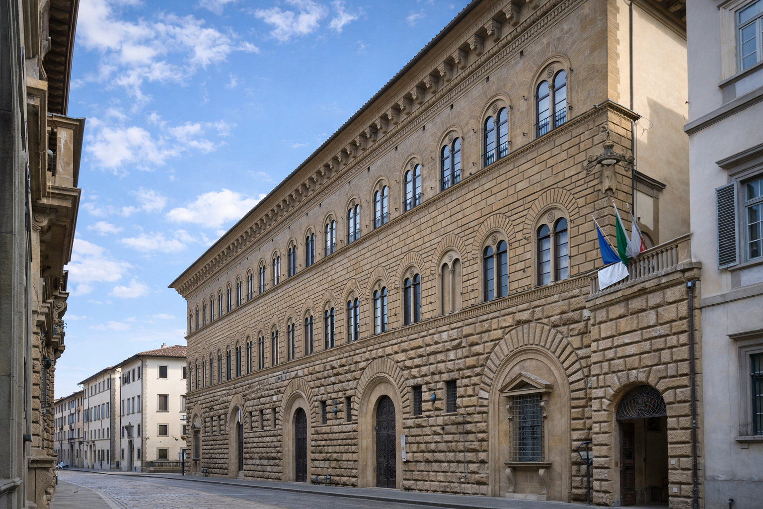 Palazzo Medici Riccardi street facade with arched windows and rusticated masonry.