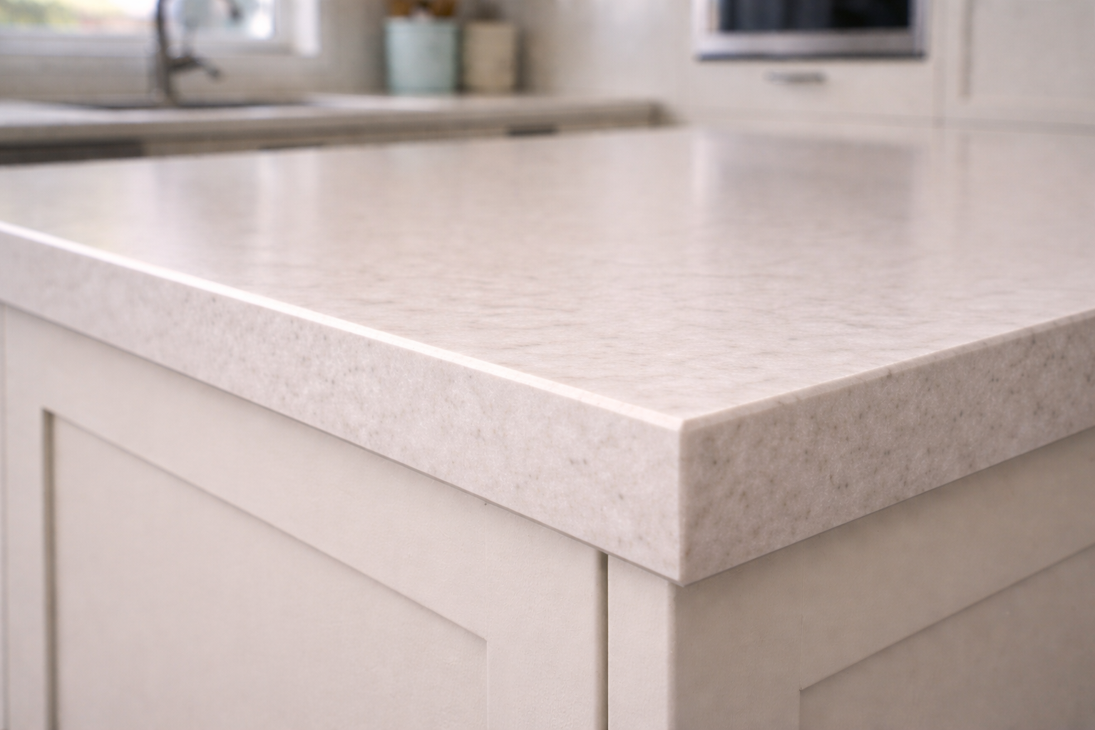 Close-up of a straight-edge quartz countertop on a modern kitchen island.