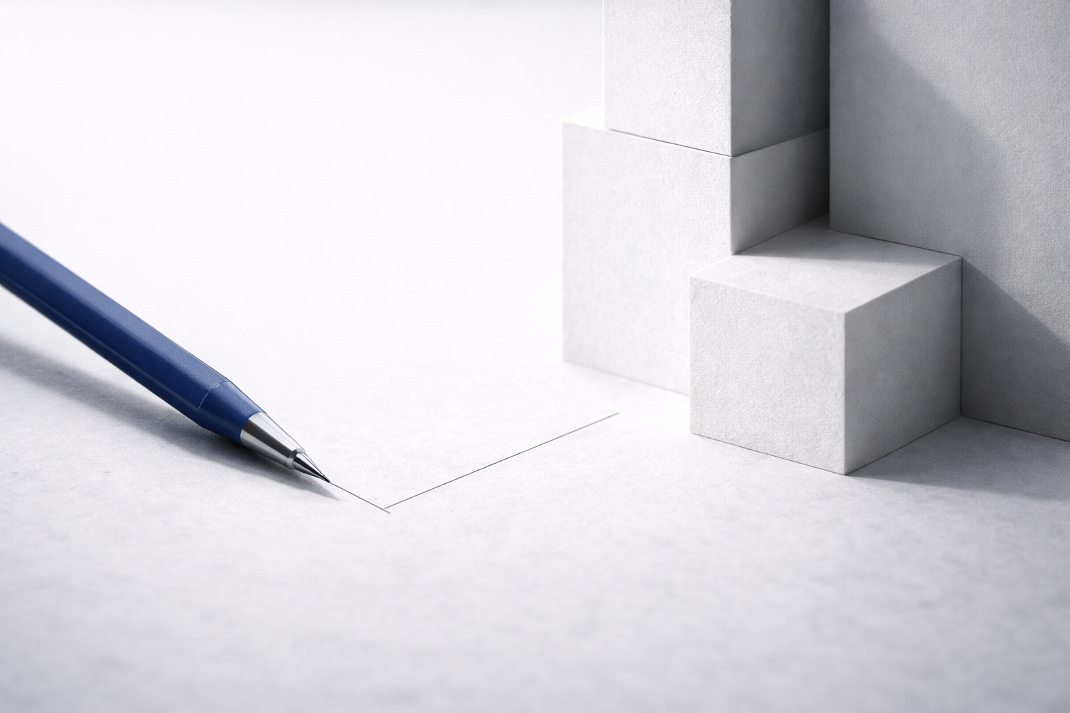 Minimal block model and blue pencil showing core architecture design basics.