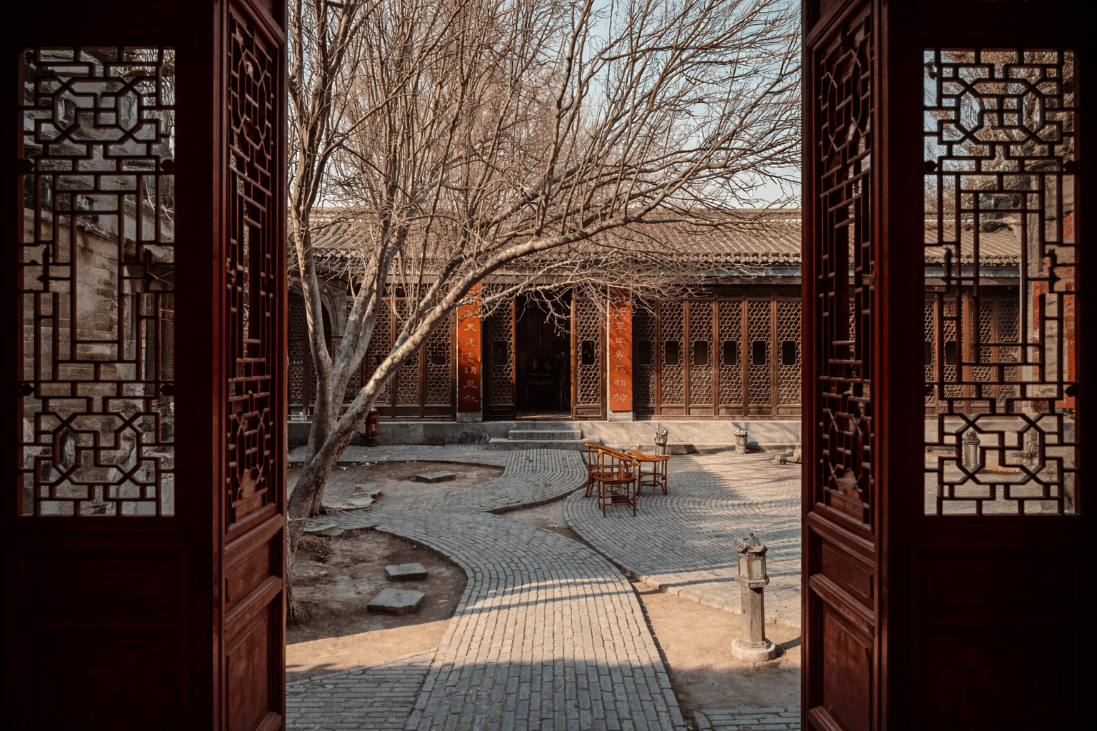 View into a traditional Chinese courtyard framed by wooden lattice gates and curved brick paths.