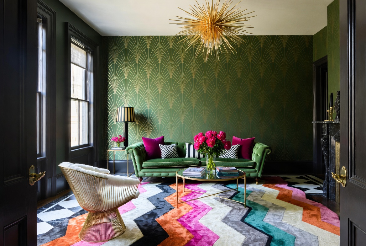 Colorful Deco-inspired living room with green velvet sofa, fan-pattern wall covering, and bold geometric rug.