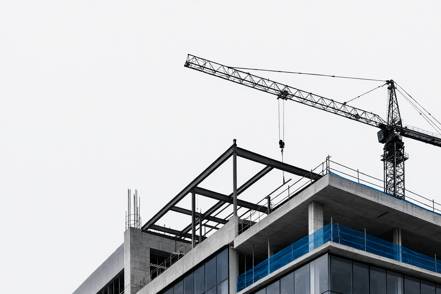 Commercial building construction showing structural frame, concrete slabs, glazing, and tower crane.