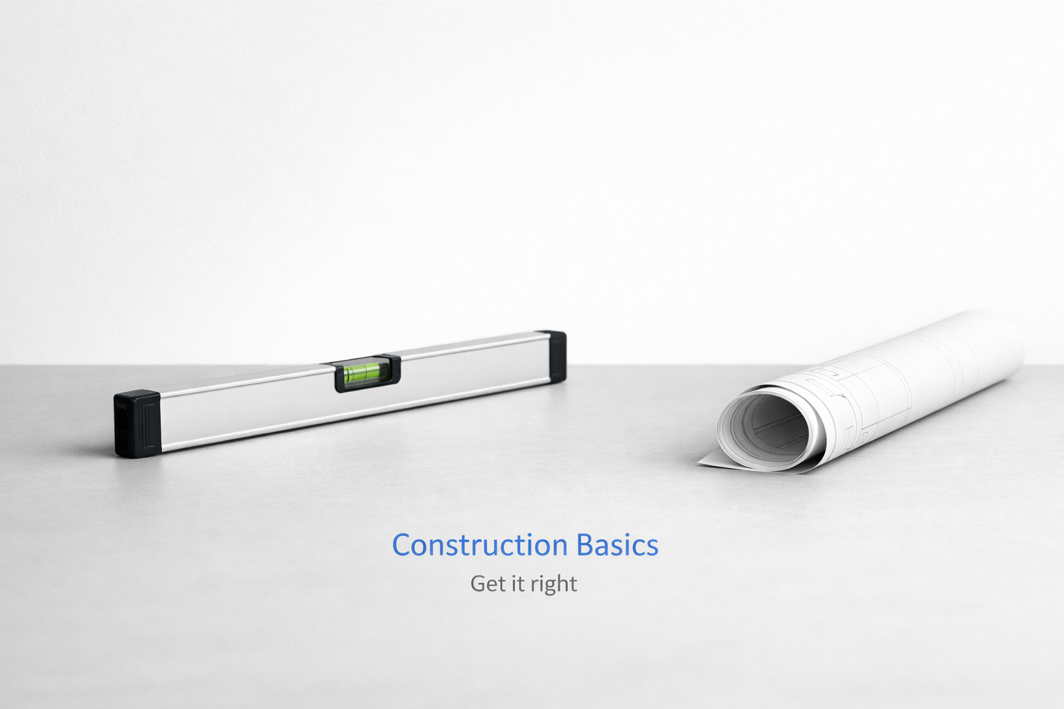 Level and rolled blueprint on a minimal surface for construction basics.