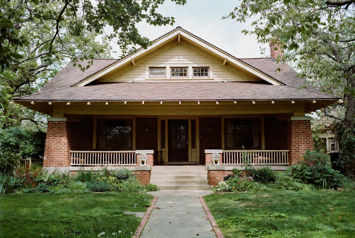 Early twentieth-century Craftsman house with broad eaves, grouped windows, and a deep front porch.