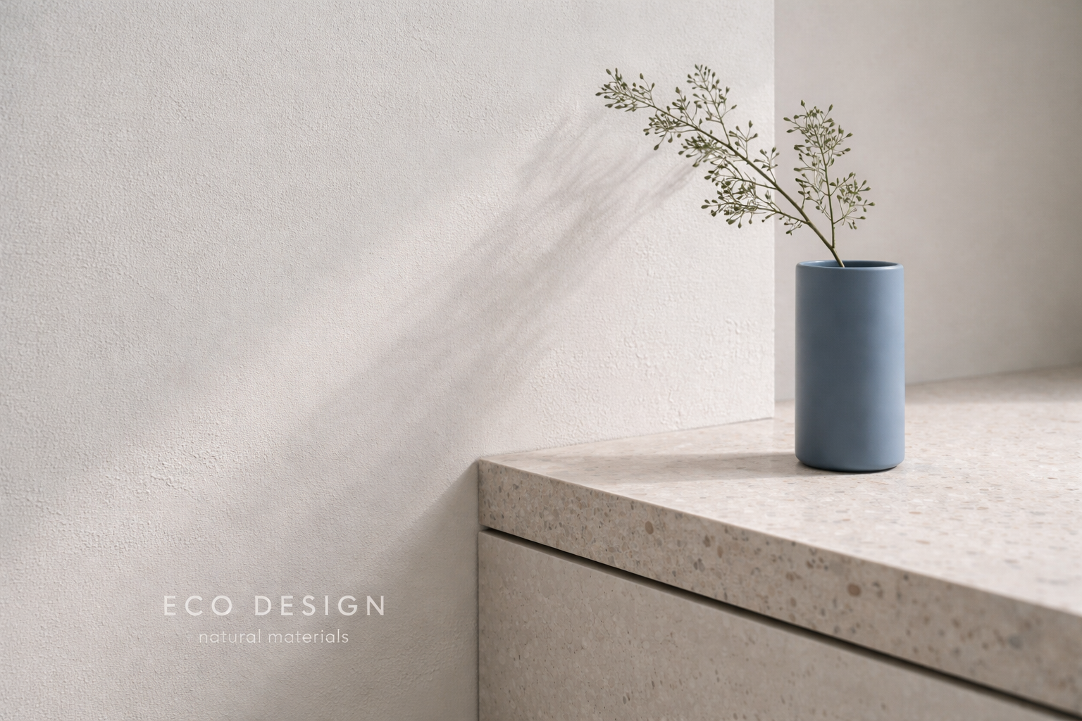 Eco-friendly interior design detail with terrazzo counter and cobalt vase in natural light.