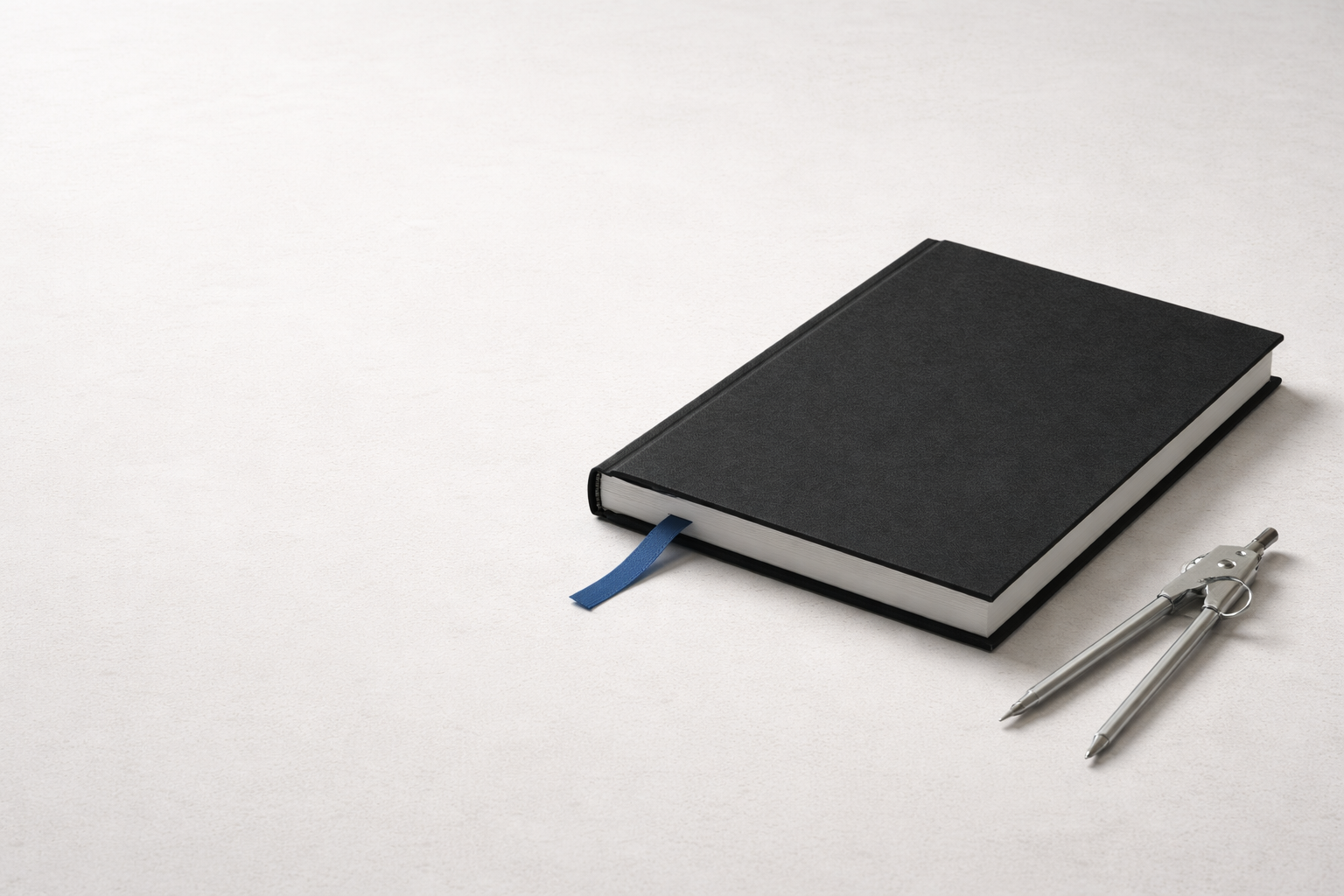 Graduate studies in architecture concept image with black portfolio, blue bookmark ribbon, and divider tool.