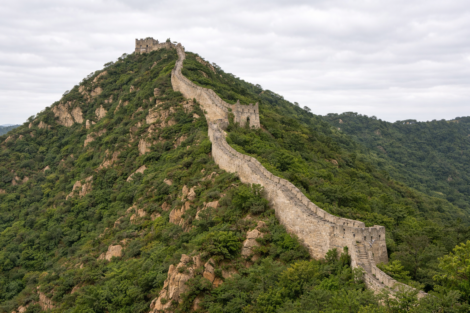 Stone Great Wall winding across a forested mountain ridge with historic watchtowers.