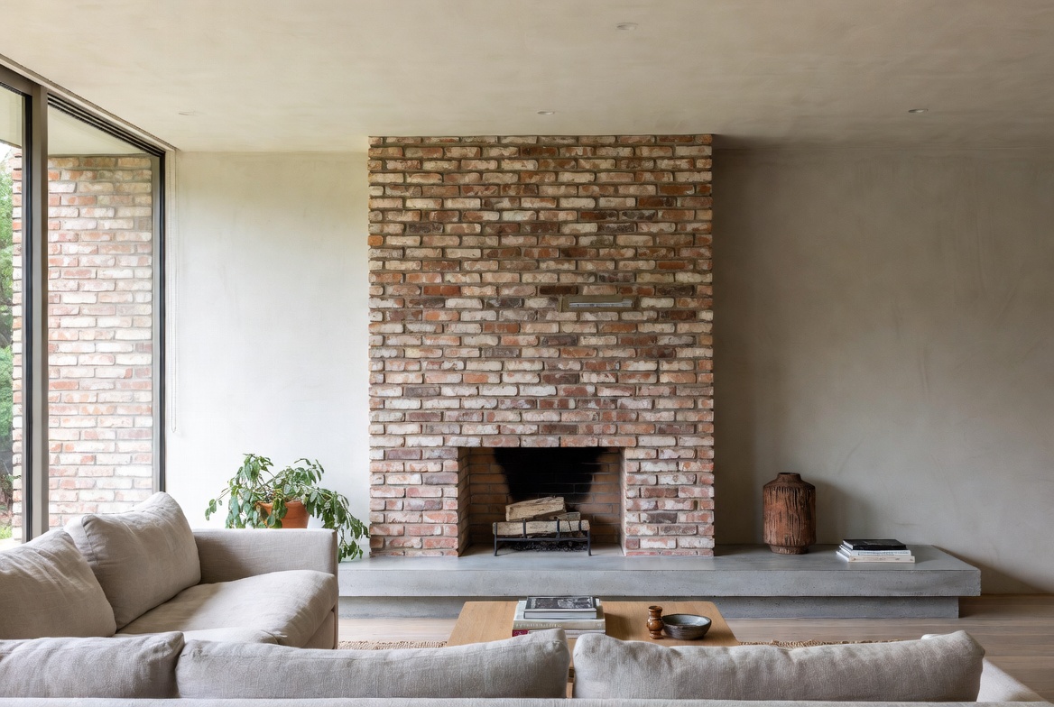 Modern living room with brick fireplace in clean contemporary design.