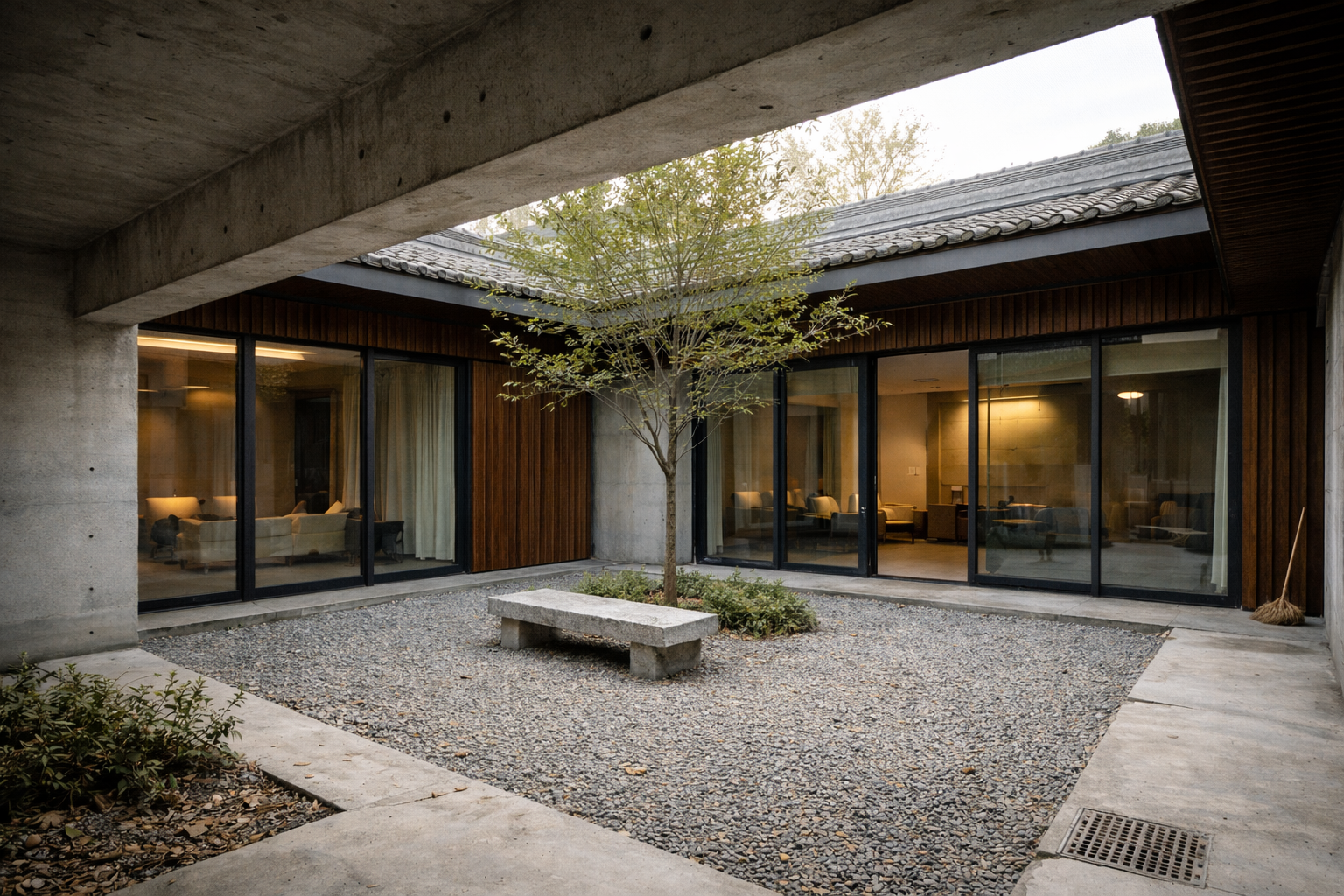 Modern siheyuan courtyard house with concrete frame, timber screens, sliding glass, and gravel court.
