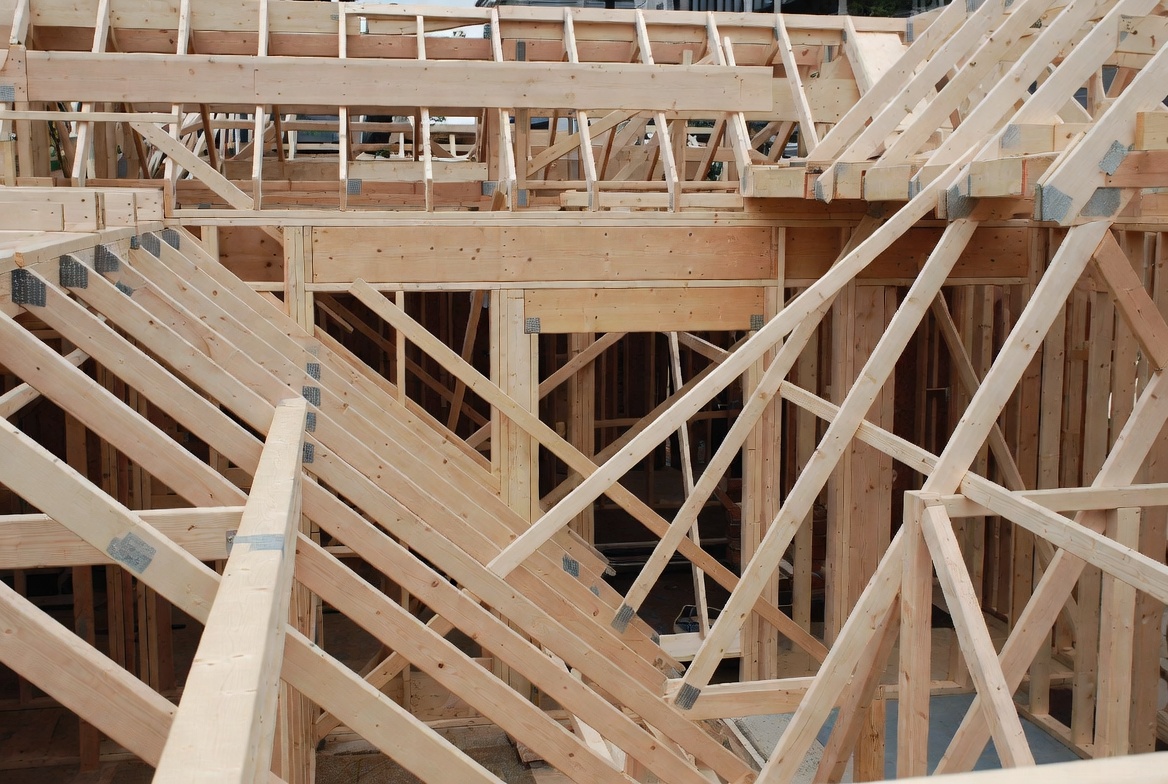 Diagonal roof bracing installed across wood framing during house construction.