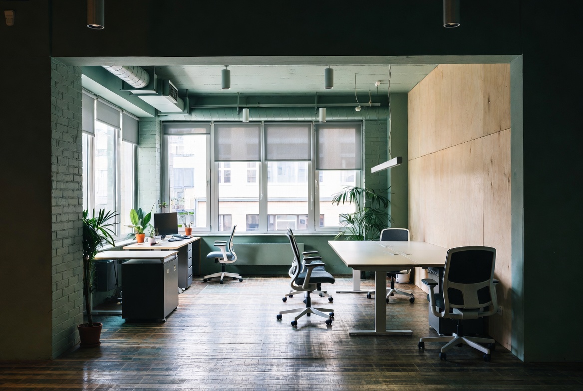 Practical green building office workspace showing natural daylight, operable shading, natural materials and simple lighting.