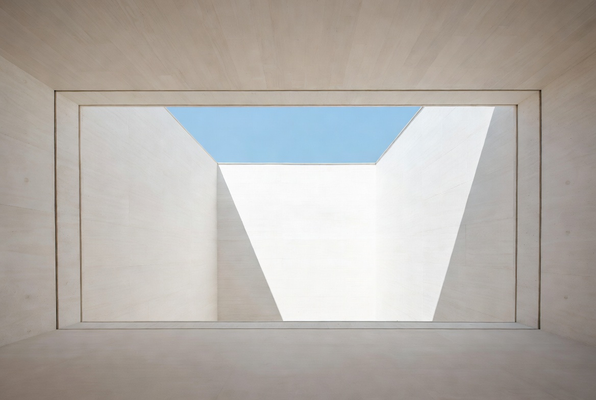 Framed architectural void formed by white concrete walls and layered openings to the sky.