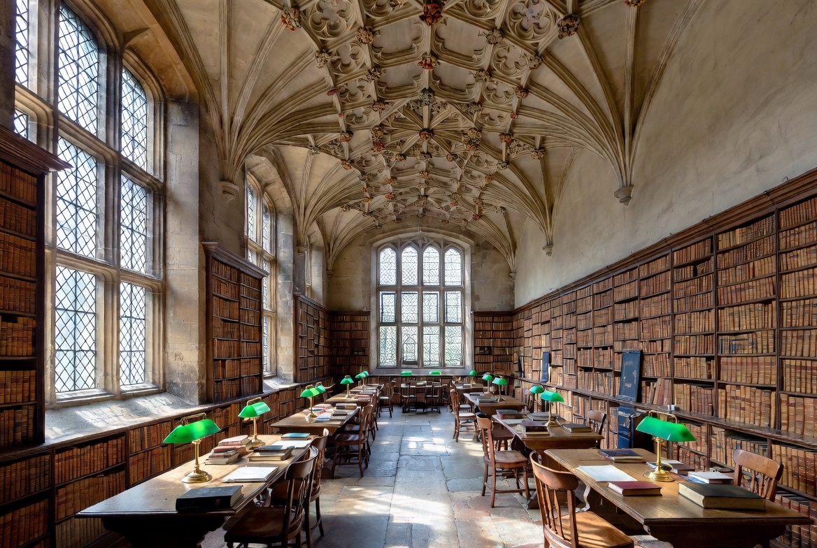 Gothic interior with pointed arches, vaulted ceiling, and long reading-room character.