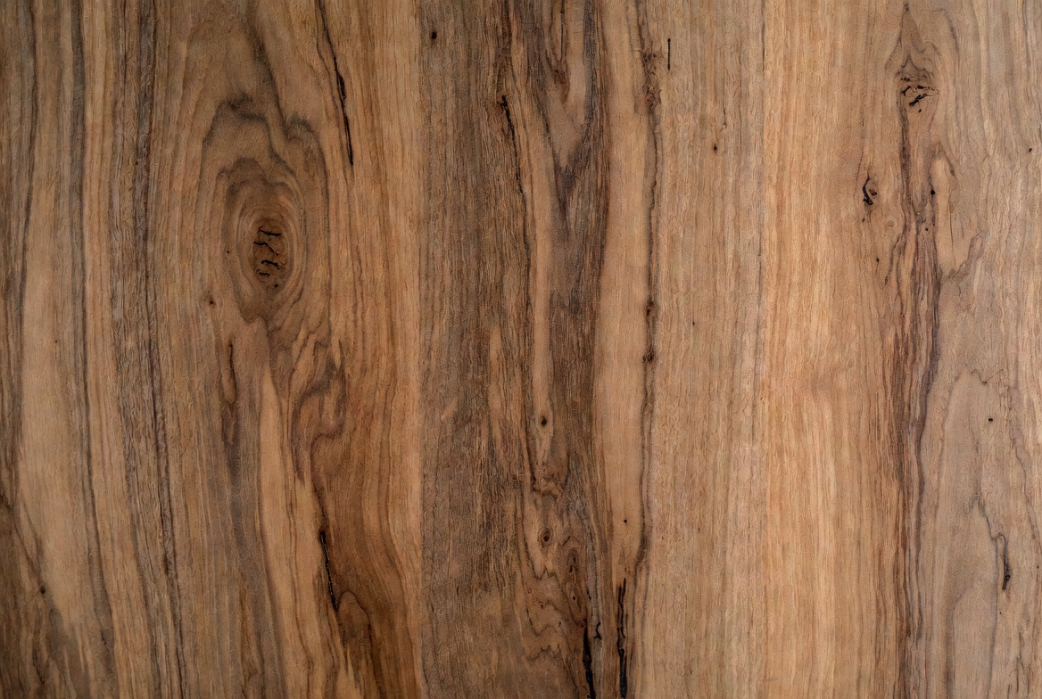 Close-up of hardwood grain with natural color variation and visible figure across the board face.