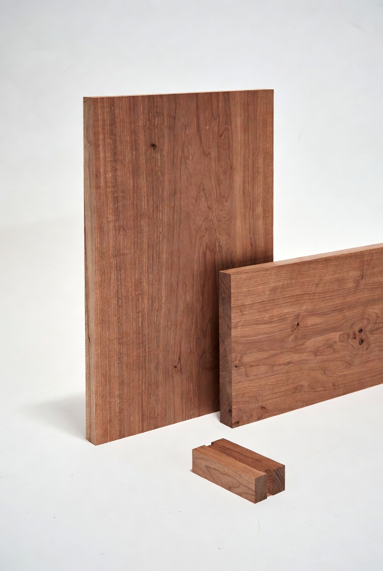 Mahogany boards and smaller solid wood blocks arranged.