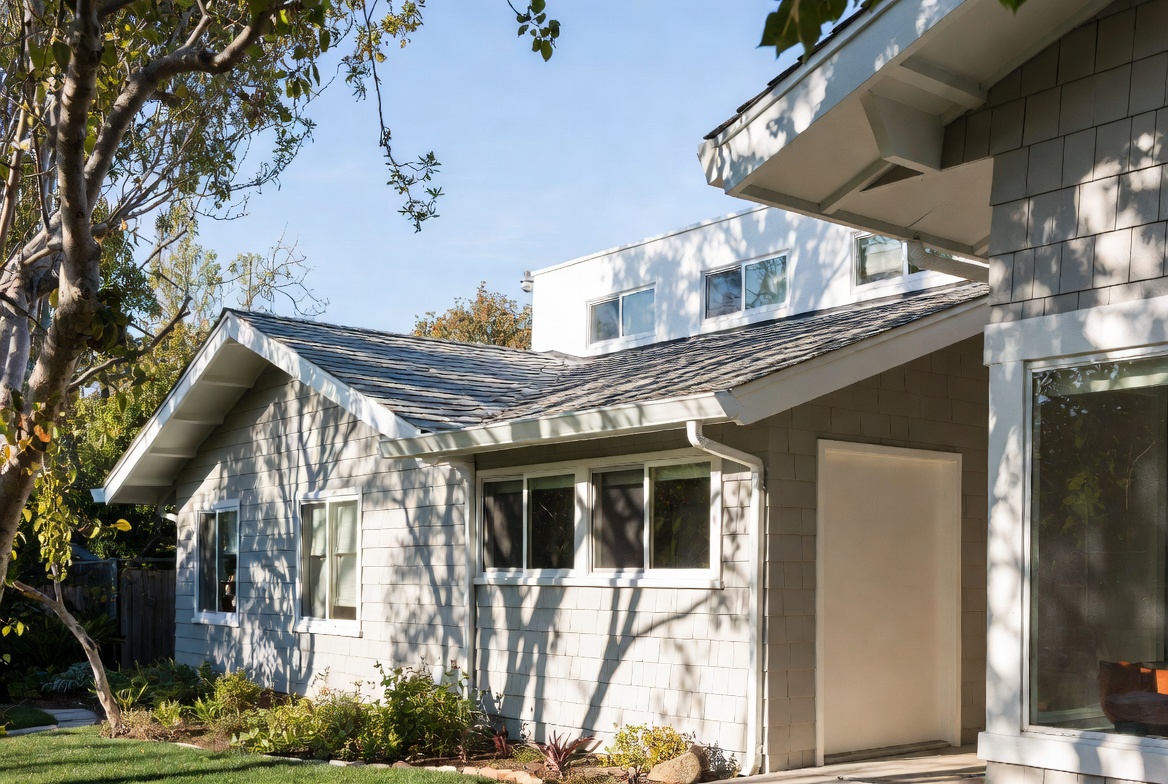 Roofline junction where a modern addition meets the original ranch house.