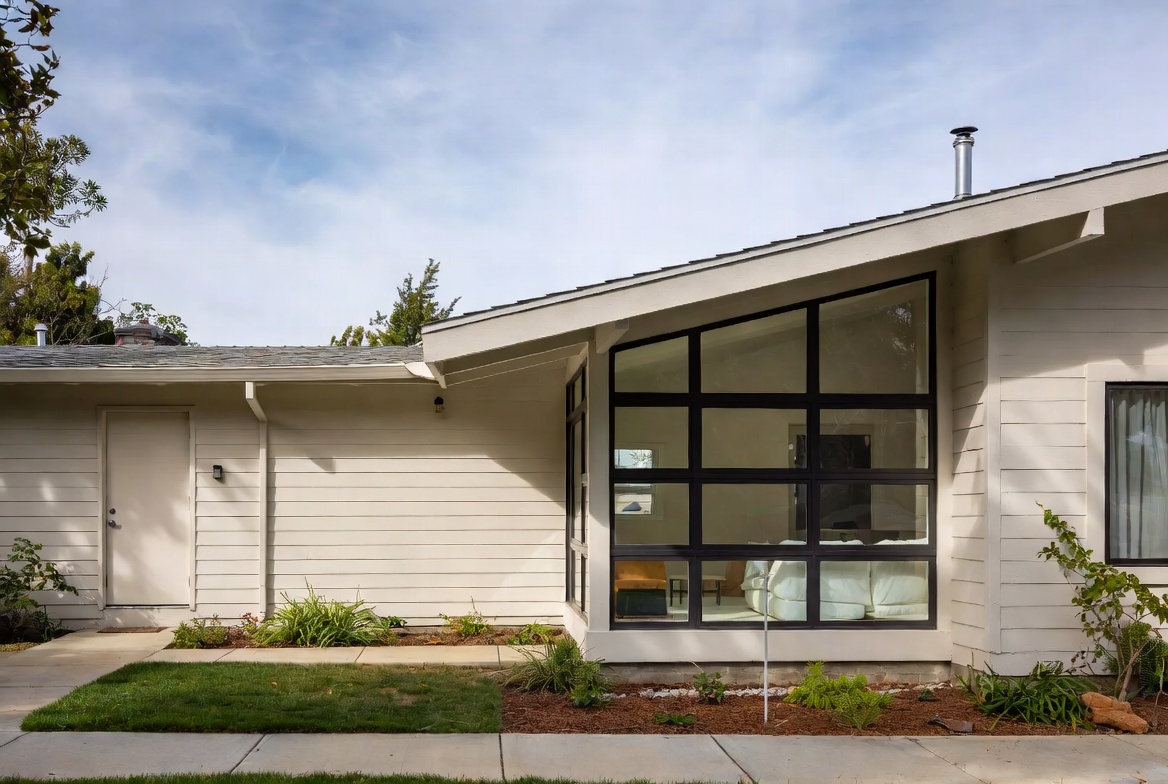Modern window volume added to a ranch house while keeping the original low roofline.