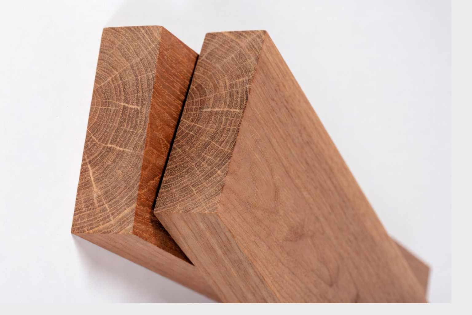 Stacked mahogany boards showing warm reddish-brown tone, face grain, and visible end grain.