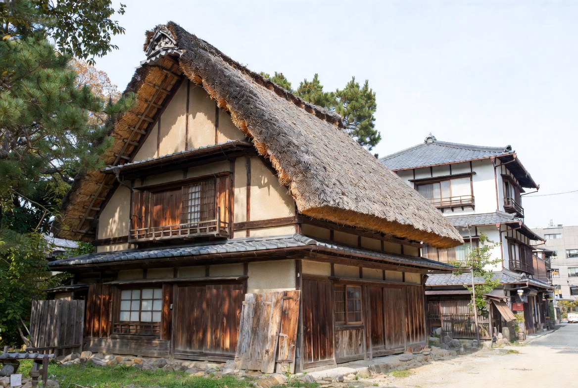 Traditional Japanese house types shown side by side, including a steep thatched rural house and an urban townhouse.