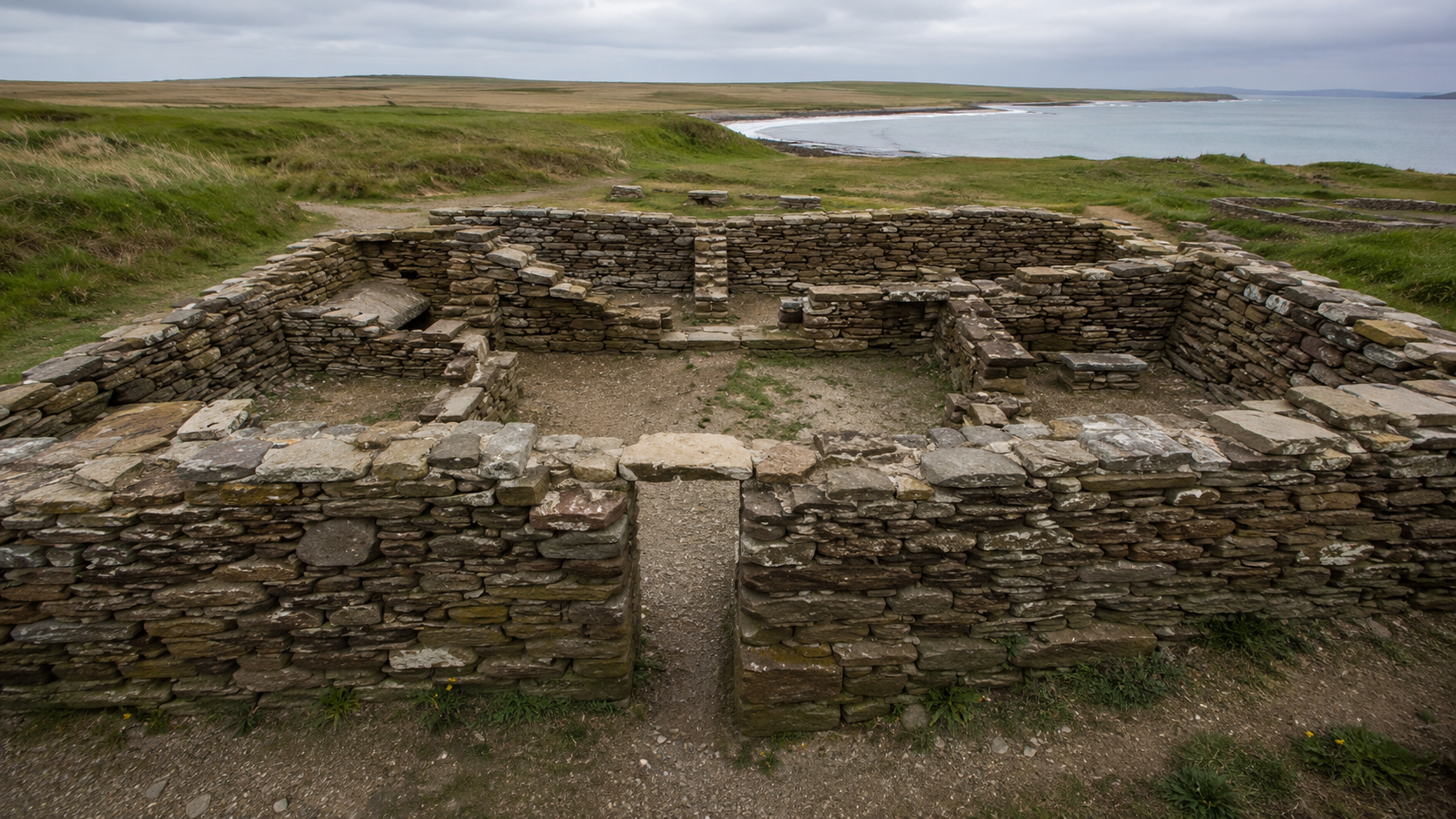 Neolithic stone house remains with thick walls and a small doorway.