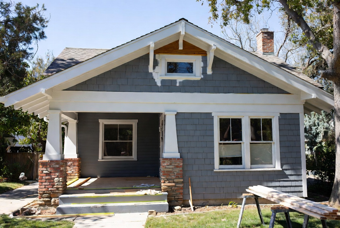 Craftsman house exterior with porch repair work, boards, and tools.