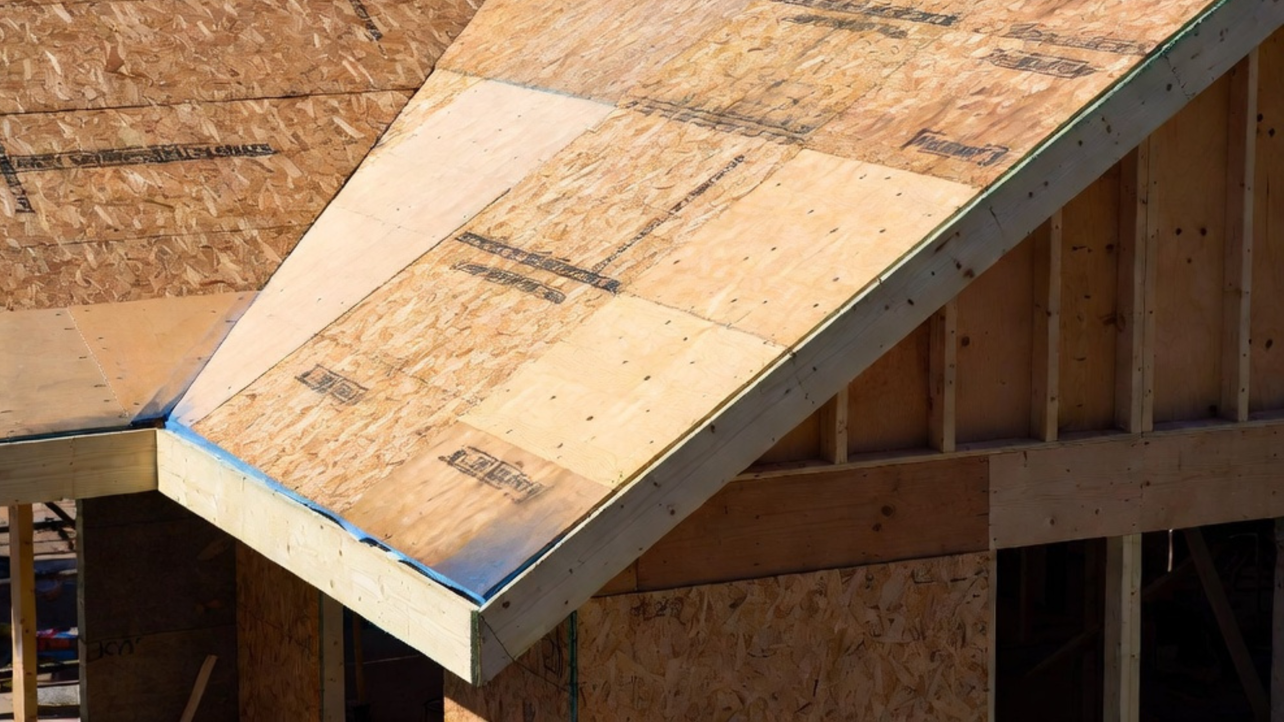 Mixed OSB and plywood roof sheathing panels installed before underlayment.