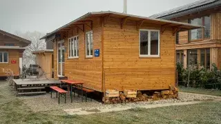A prebuilt wooden small house with a simple, functional design.
