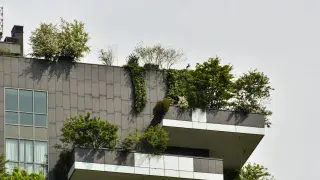 A modern building with balcony gardens, integrating plants for natural cooling, aesthetics, and sustainability.