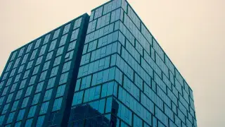 Modern glass commercial building in a downtown area.