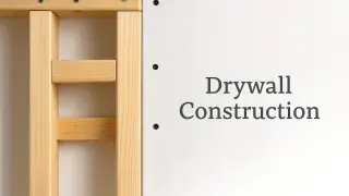 Worker installing drywall over framed wall structure.