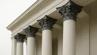 Greek Revival columns with Corinthian capitals.