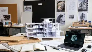 A working architecture studio desk showing physical massing models.