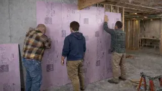 Basement foam board insulation installed on concrete foundation wall during framing and air sealing.
