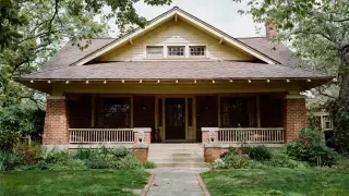 Early twentieth-century Craftsman house with broad eaves, grouped windows, and a deep front porch.