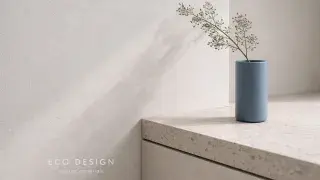 Eco-friendly interior design detail with terrazzo counter and cobalt vase in natural light.