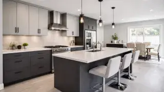 Modern grey modular kitchen with two-tone cabinetry, a large island, and matte black hardware.
