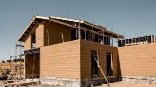Finished rammed earth home with thick walls and deep window openings.