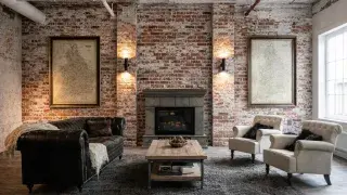 White industrial loft living room with rough plaster ceiling, exposed brick accents, leather sofa and fireplace.