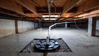 Crawl space sump basin with sealed ground liner and interior drainage system.
