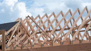 Timber roof trusses with diagonal bracing during residential framing.
