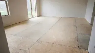 Exposed OSB subfloor in an empty room before finish flooring is installed.