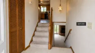 Cramped split-level entry before remodeling with carpeted stairs, a narrow landing, oak railing, and a coat closet.