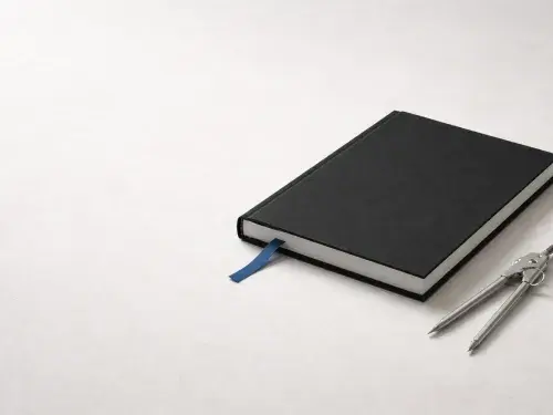 Graduate studies in architecture concept image with black portfolio, blue bookmark ribbon, and divider tool.