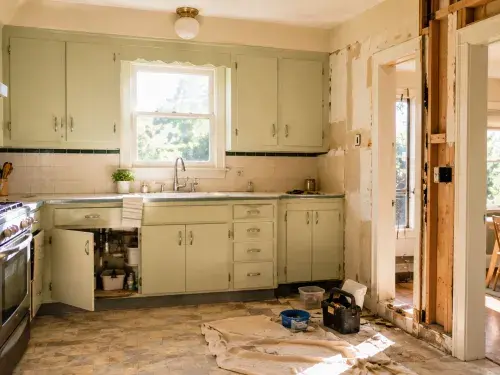 1950s kitchen remodel showing original cabinets, appliance updates, wall repair, and old-house renovation work.