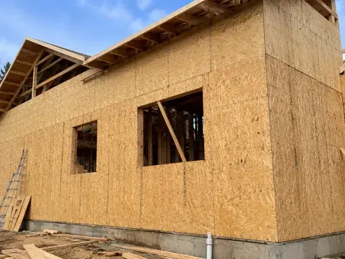 Exterior wall sheathing panels installed on wood framing before housewrap and siding.