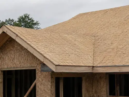 Roof sheathing panels installed over rafters before underlayment and shingles.