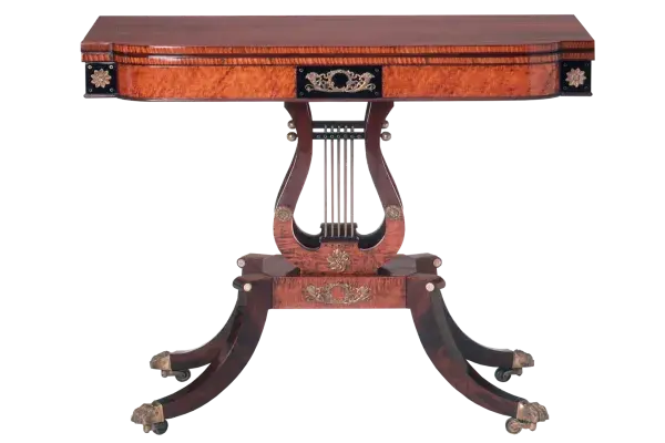 An ornate card table made from mahogany wood, featuring intricate details and a classic design.