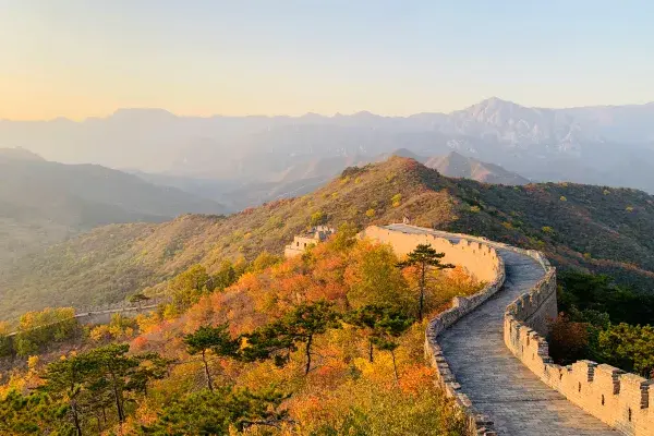 The Great Wall of China across green hills.