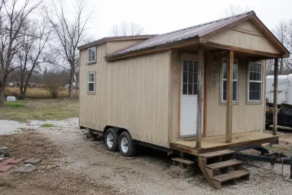 Tiny home on wheels parked in a residential yard.